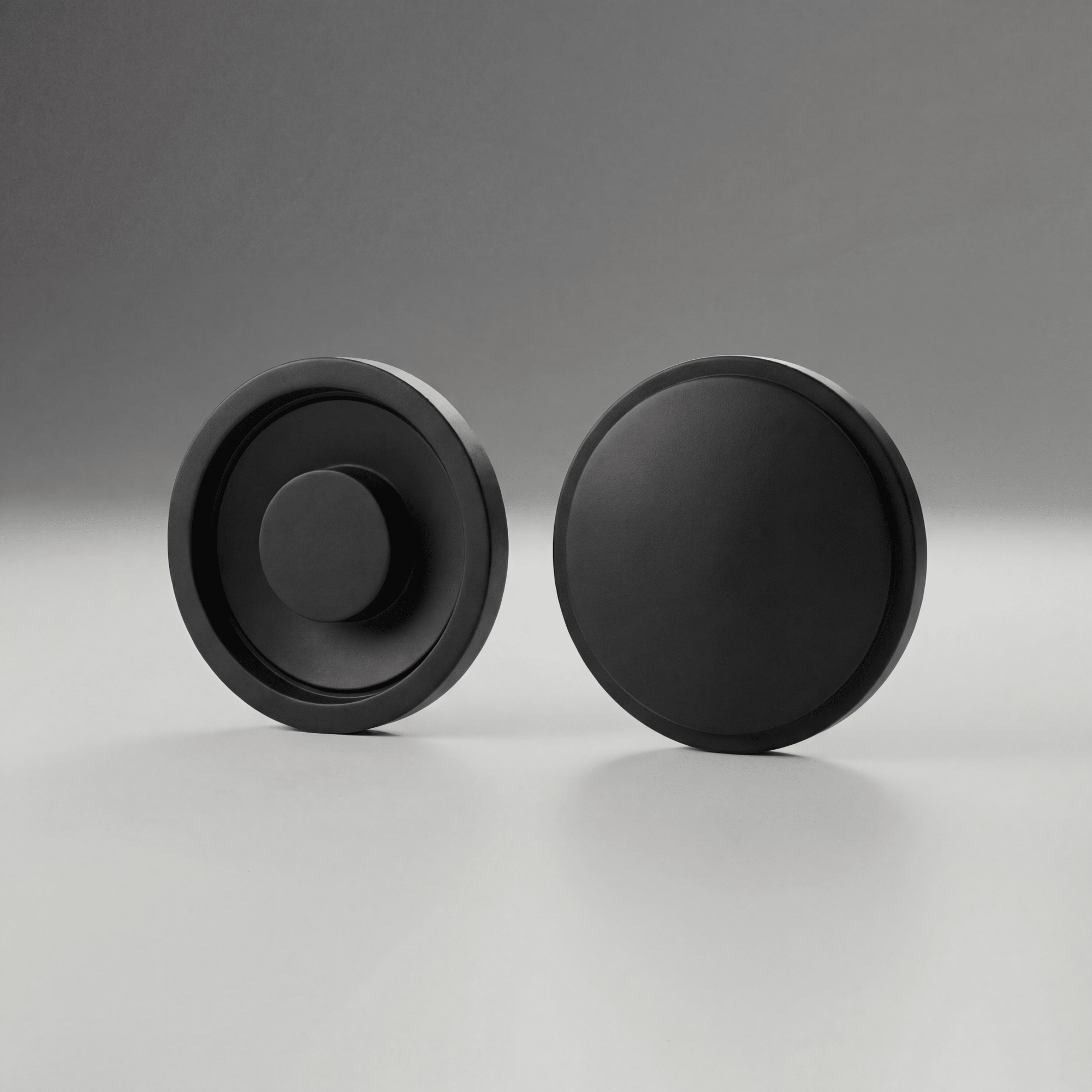 Two black Maglite Replacement Switch Seal Magcharger 108-000-643 on a gray background