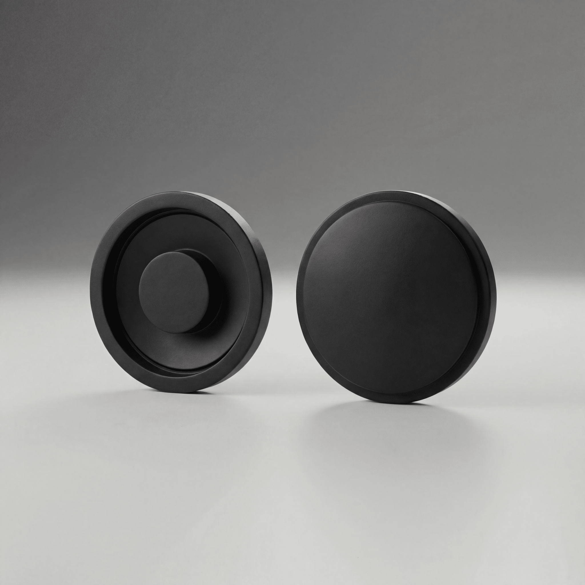 Two black Maglite Replacement Switch Seal Magcharger 108-000-643 on a gray background
