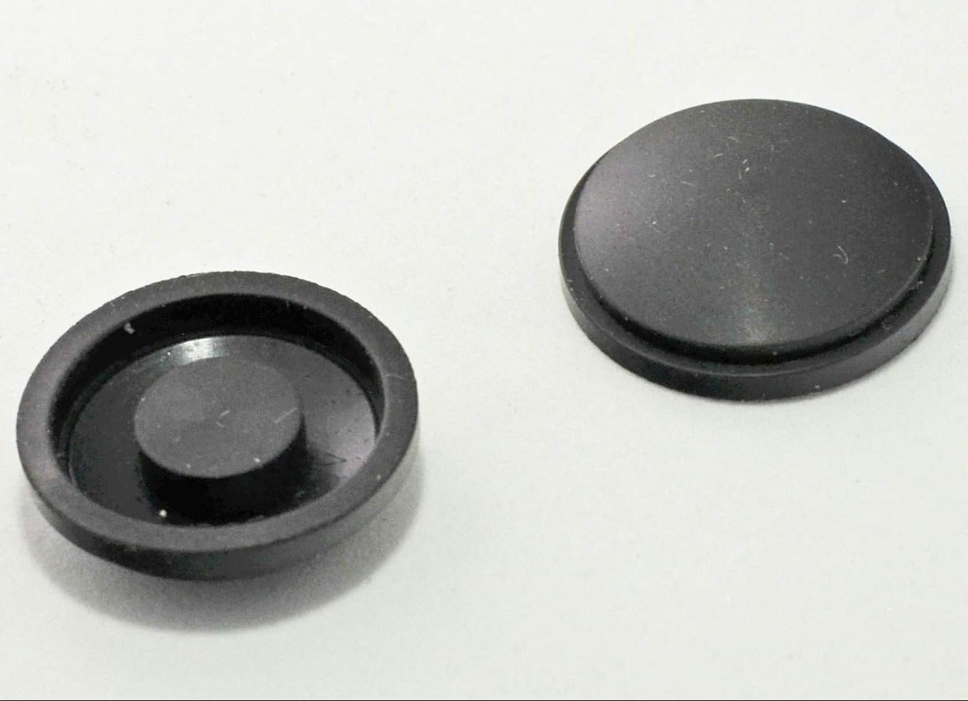 Two black Maglite Replacement Switch Seal Magcharger 108-000-643 on a white background