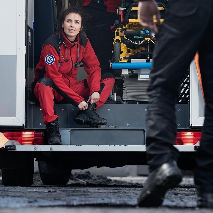 Paramedic sitting in an ambulance wearing Magnum Strike Force waterproof boots