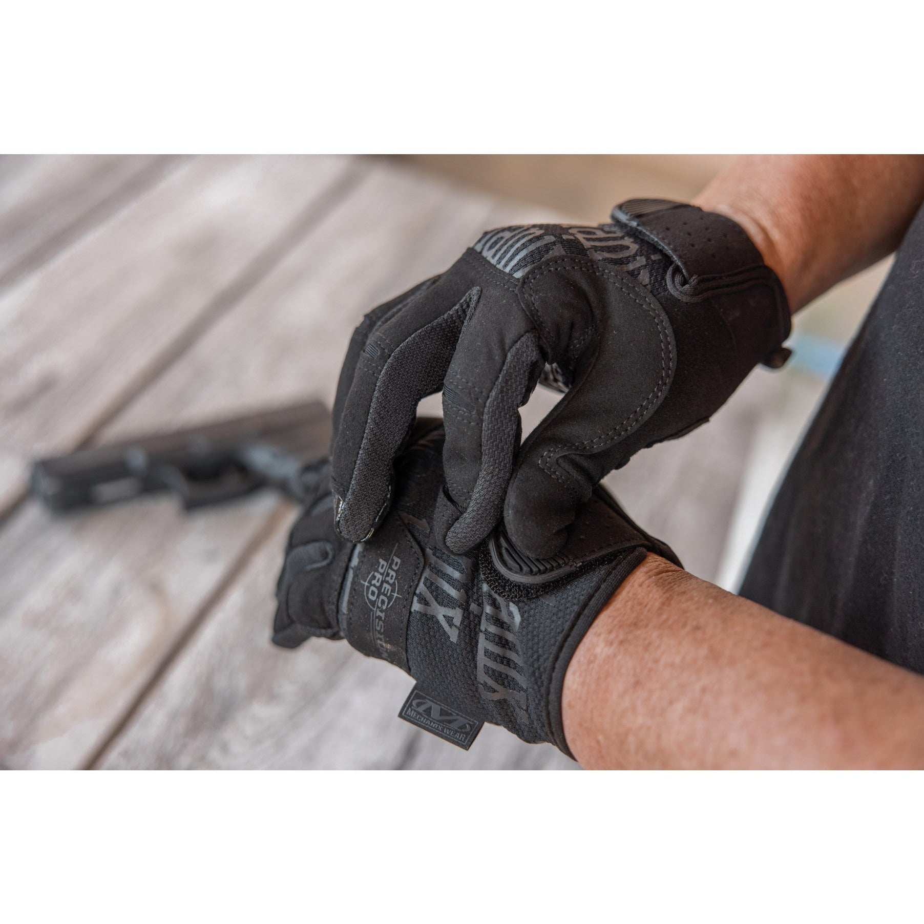 Close-up of the Mechanix Wear Precision Pro Covert glove wrist cuff being adjusted