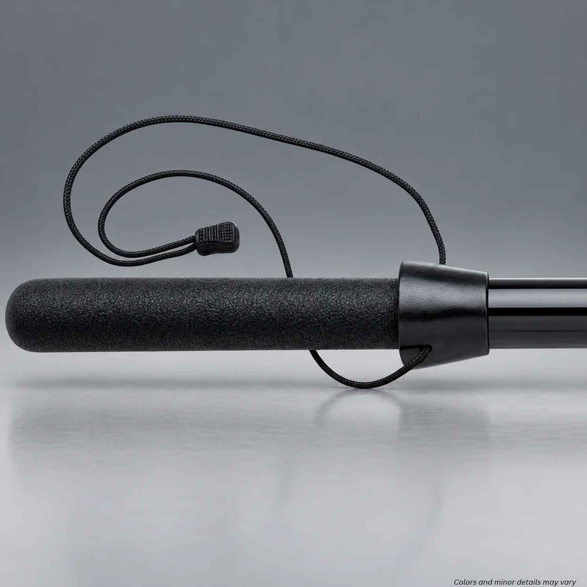 Monadnock LAPD/NYPD baton stop 2716 with black retention cord and zipper pull fitted on a straight baton, 1000187 on a gray background