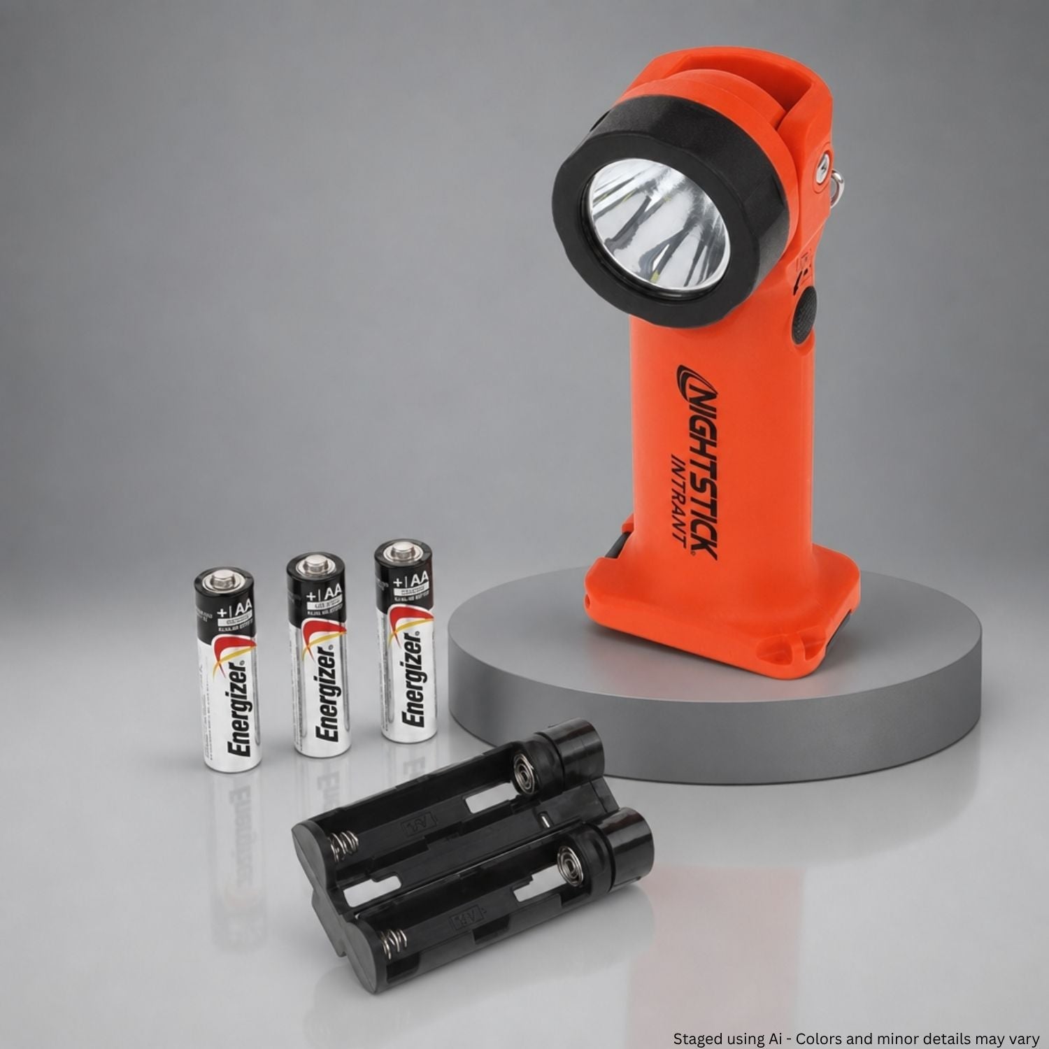 Orange flashlight with batteries on a gray background