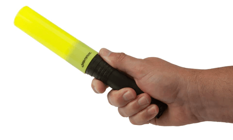 Person holding Nightstick Nesting Safety Cone flashlight, ideal for directing traffic and illuminating hazards.
