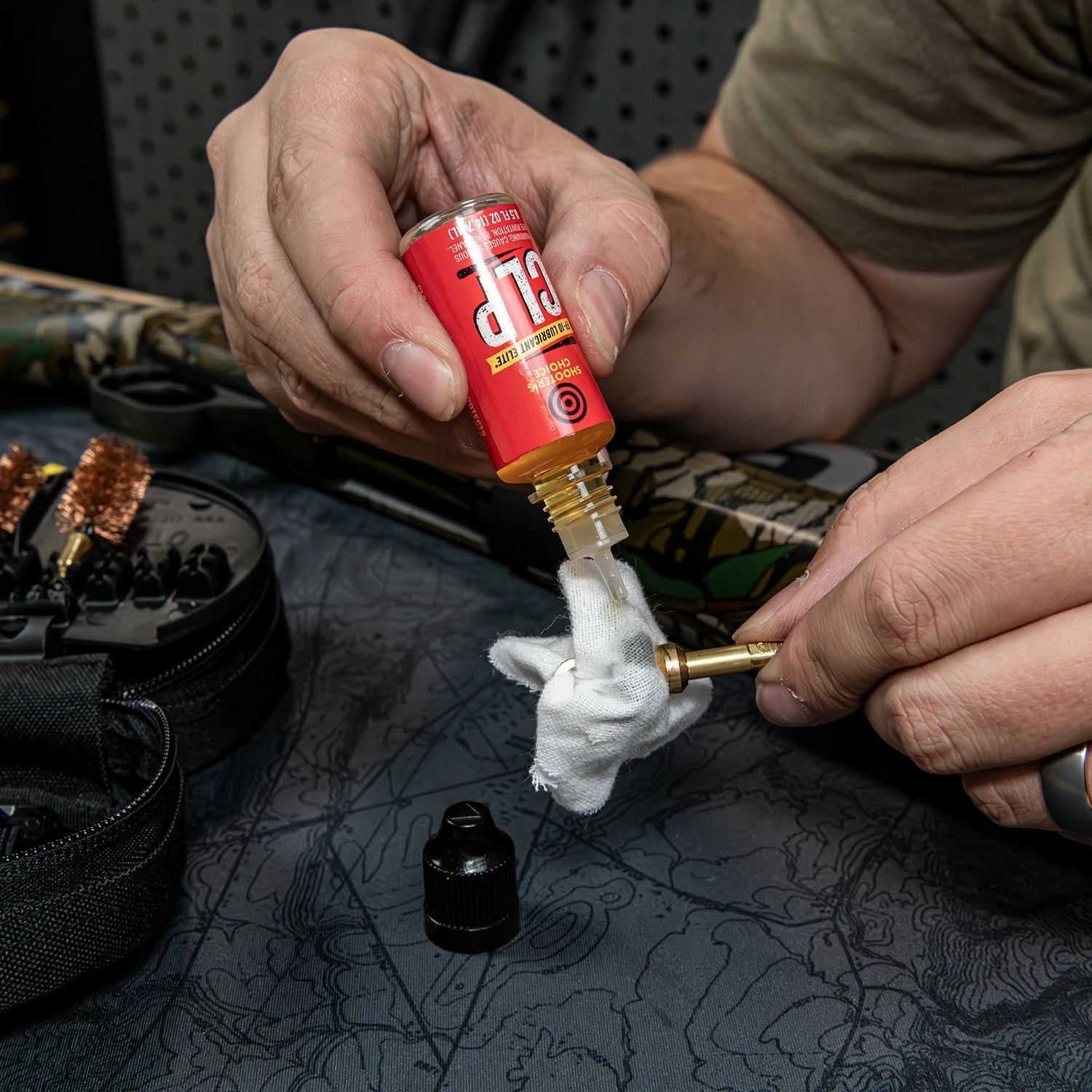 Applying Shooter’s Choice FP-10 CLP to a cotton patch from the Otis FG-410 shotgun cleaning kit