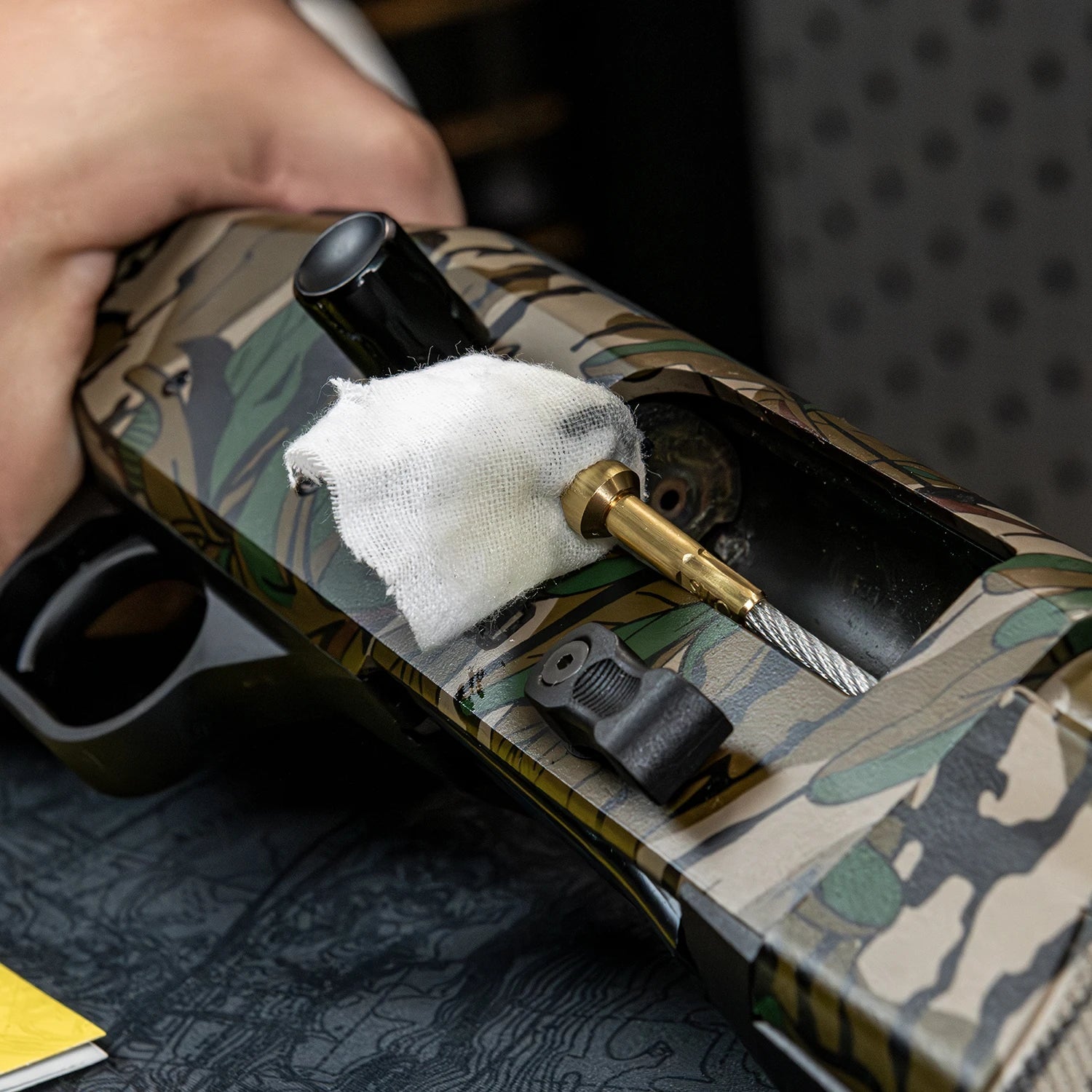 Otis FG-410 cotton patch and Memory-Flex cable entering a shotgun chamber for Breech-to-Muzzle cleaning