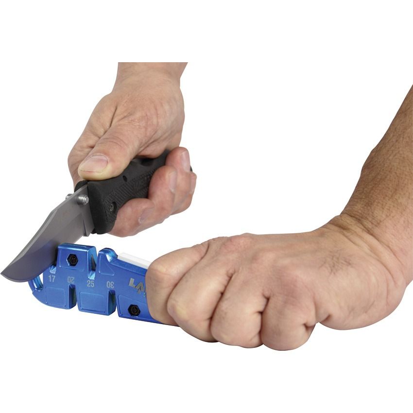 Person using the Lansky QuadSharp QSHARP to sharpen a folding knife by pulling the blade through a carbide slot