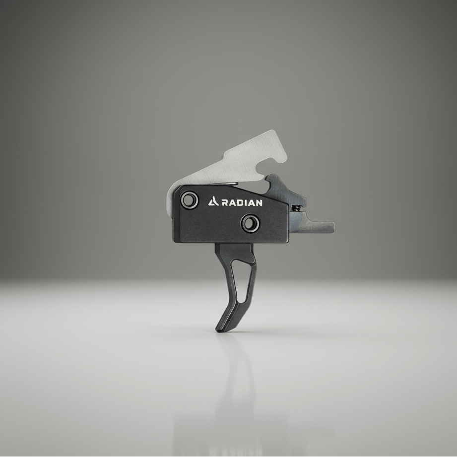 Black and gray firearm trigger on a reflective surface with a gradient gray background