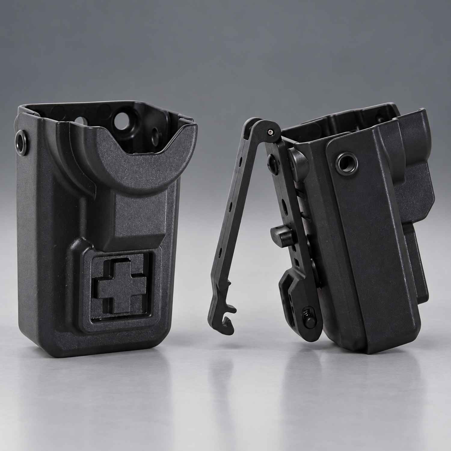 Two black plastic tactical tourniquet holsters or clip accessories shown on a clean gray studio background, one front view and one side view with the clip extended.