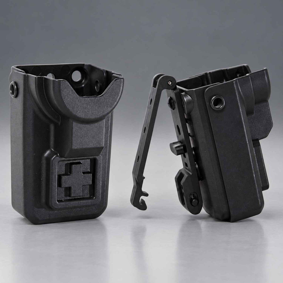 Two black plastic tactical tourniquet holsters or clip accessories shown on a clean gray studio background, one front view and one side view with the clip extended.