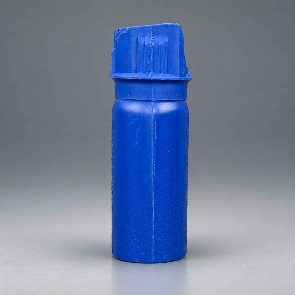 Rings Blueguns MK-3 pepper spray training replica in blue on a gray studio background