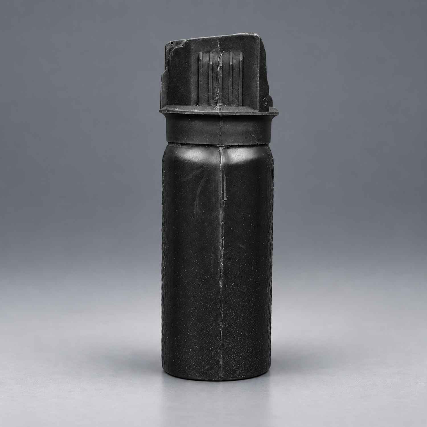 Rings Blueguns MK-3 pepper spray training replica in black on a gray studio background