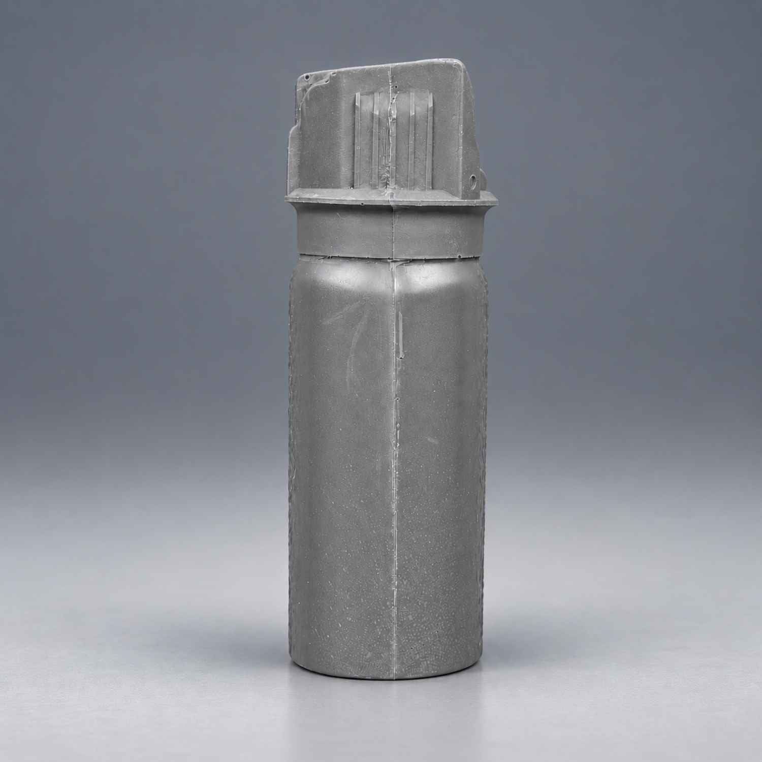 Rings Blueguns MK-3 pepper spray training replica in gray on a gray studio background
