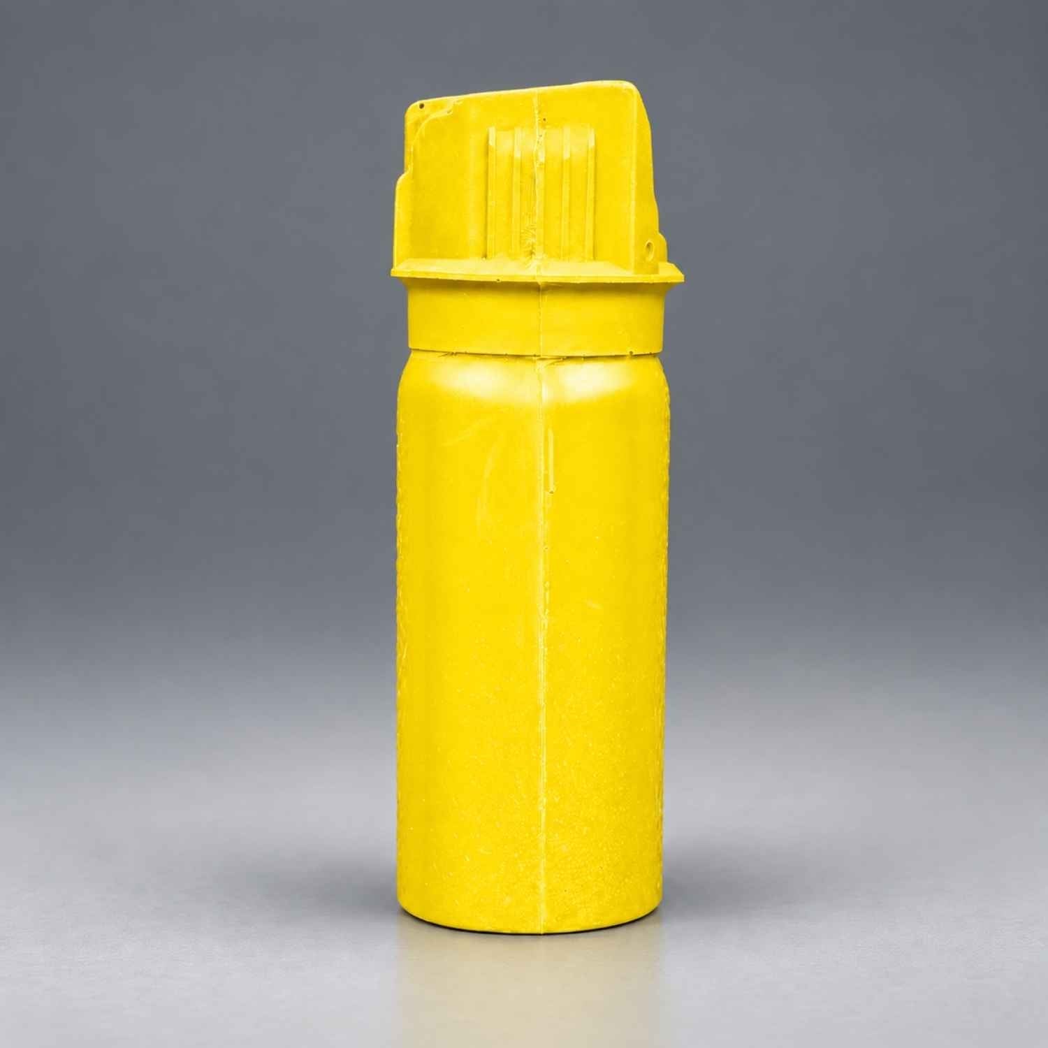 Rings Blueguns MK-3 pepper spray training replica in yellow on a gray studio background