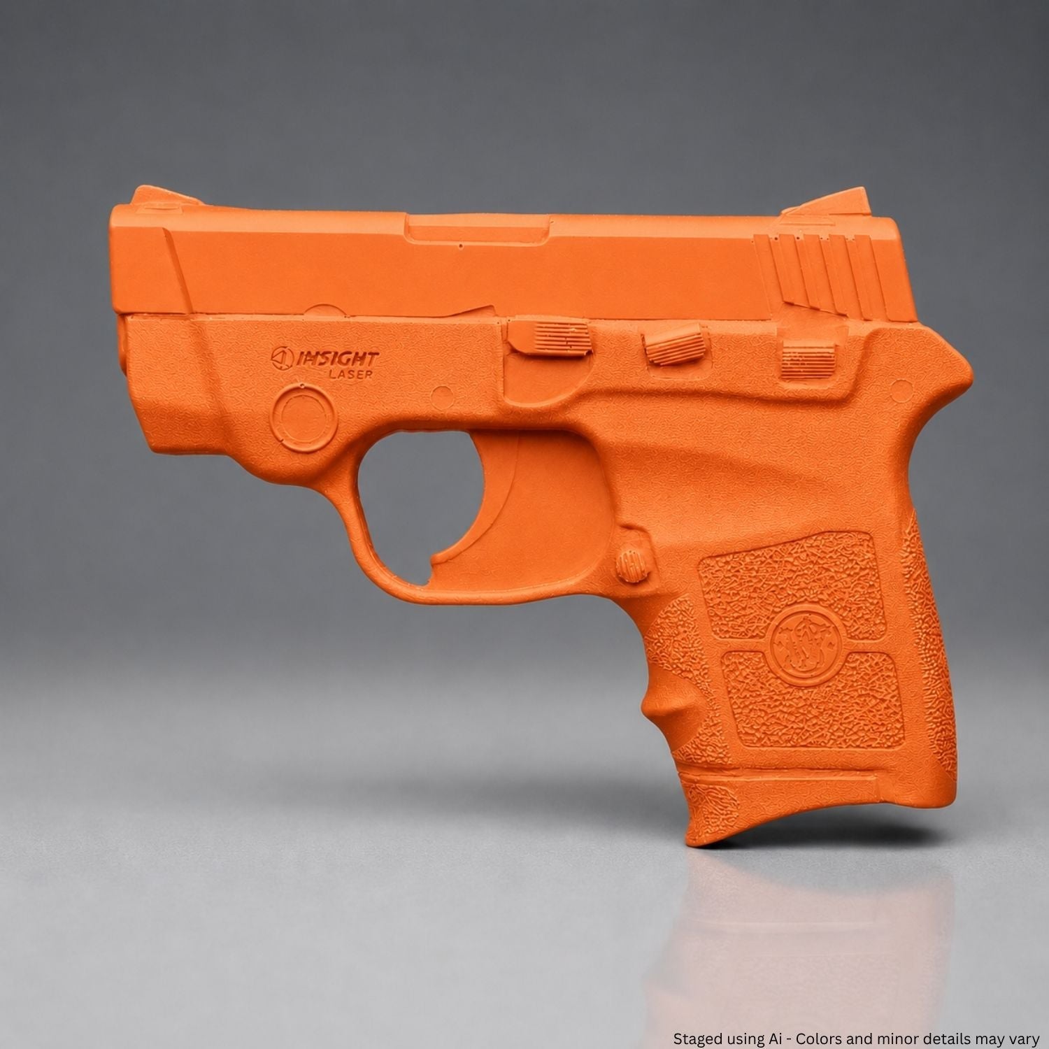 A Orange Smith & Wesson Bodyguard .380 Training Gun on a gray background
