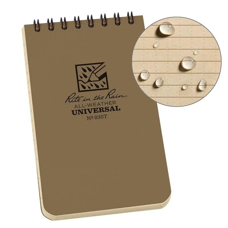 Tan notebook with 'Rite in the Rain' logo and text, showing water resistance on a wooden surface.