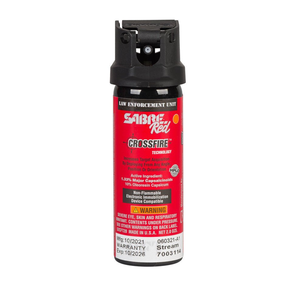 Red pepper spray canister with black cap on a white background