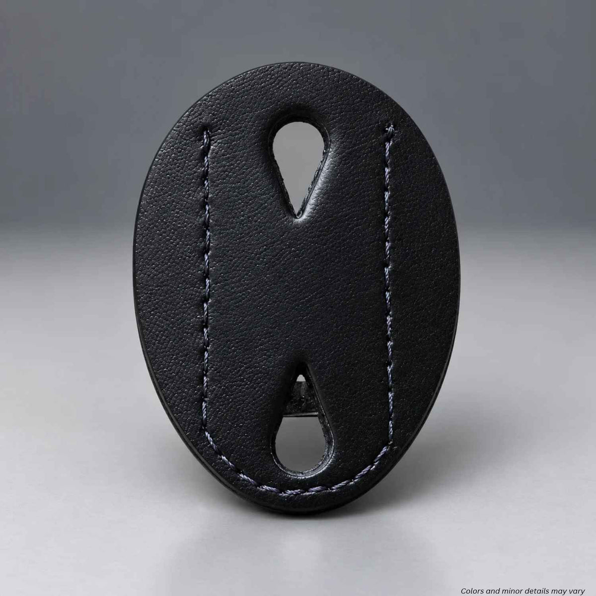 Black leather-look Safariland 7350-03 badge holder face with stitched edges and two teardrop pin slots