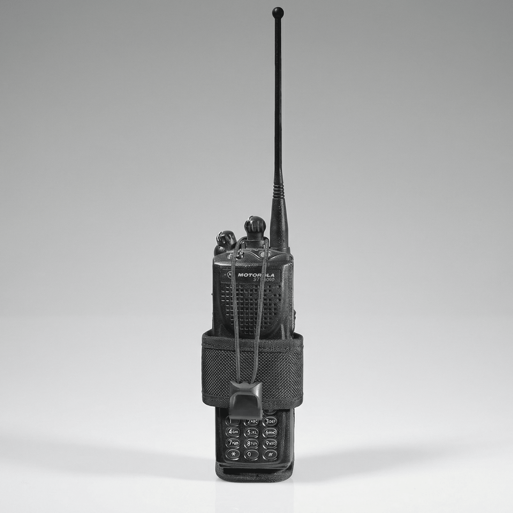 Black walkie-talkie with antenna on a gray background