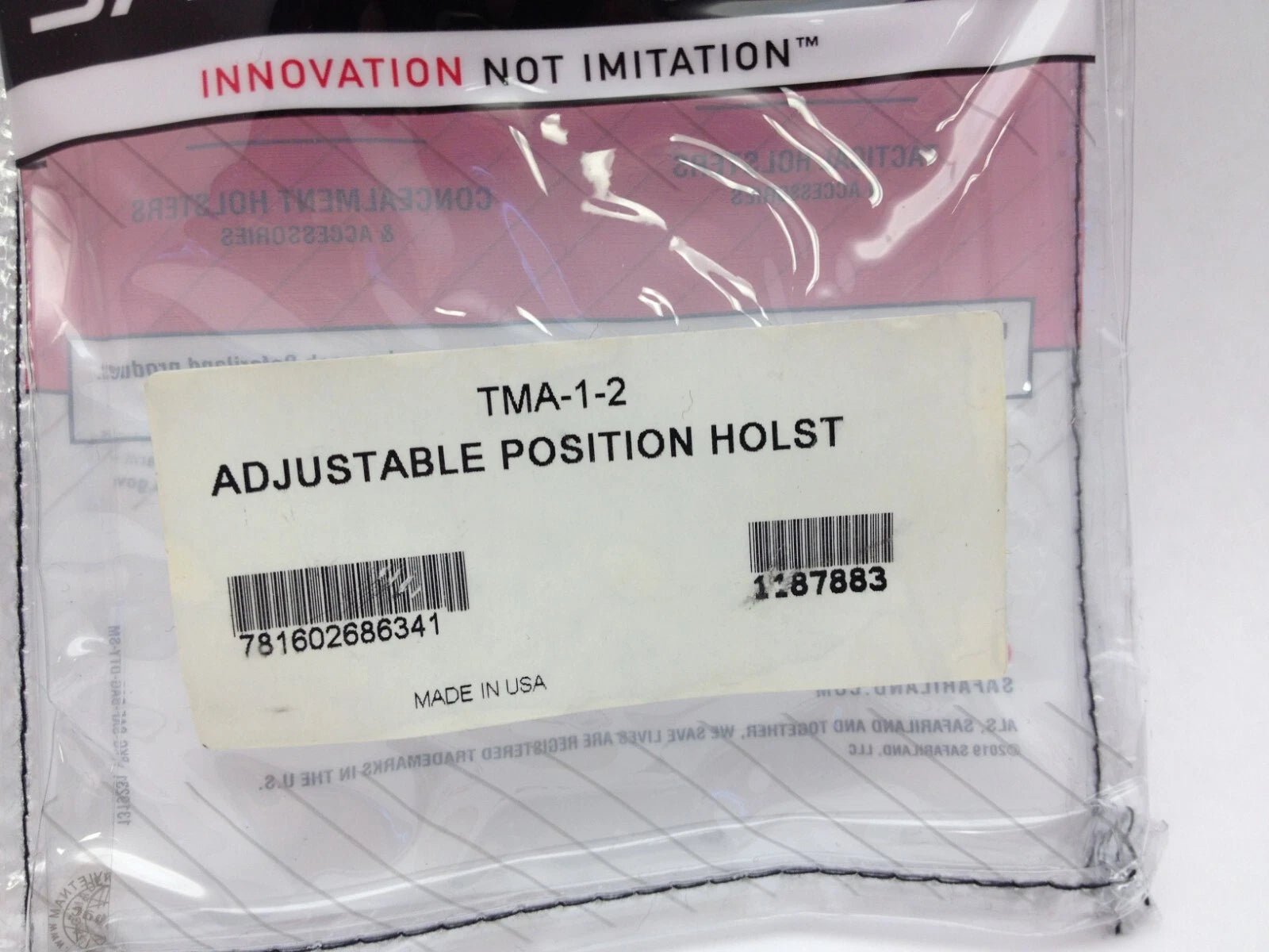 Packaged adjustable position holster with label and branding on a white background