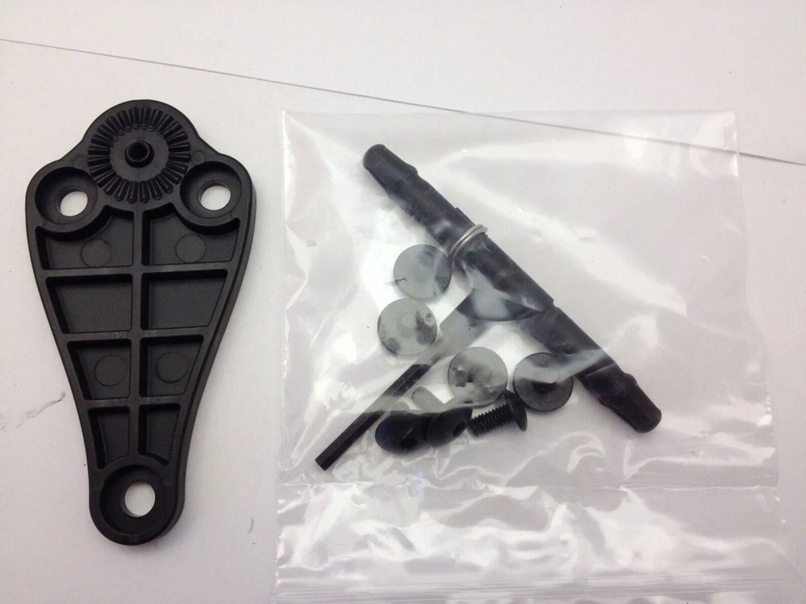 Black holster component and screws on a white background