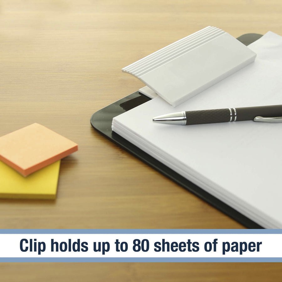 Notebook with pen, sticky notes, and clip on a wooden surface