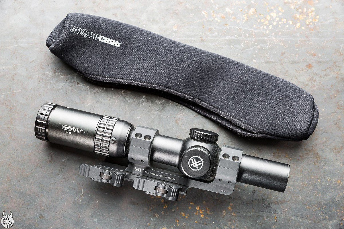 Sight on a gray surface with a black carrying case labeled 'Scope Dust'.