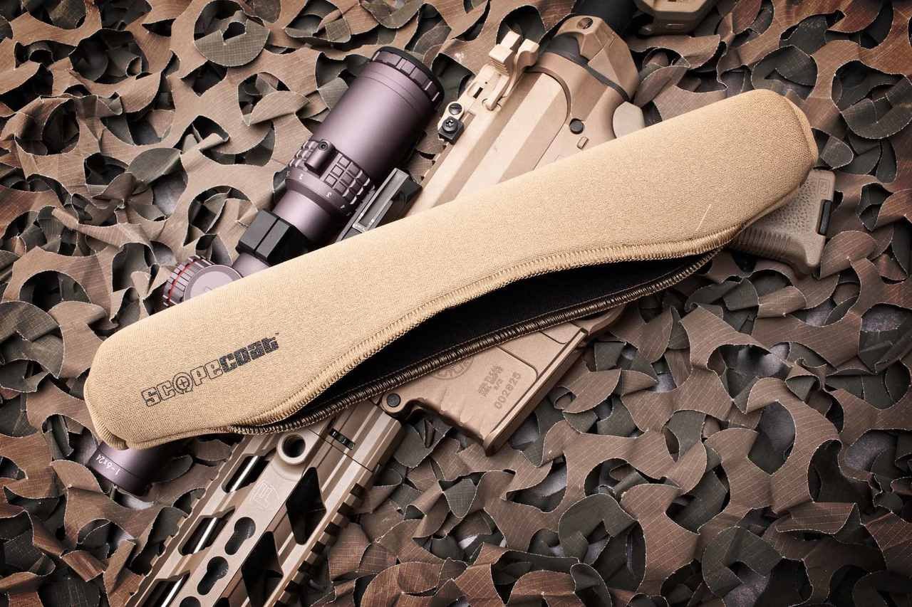 Fishing reel with camouflage cover on a camouflage-patterned surface