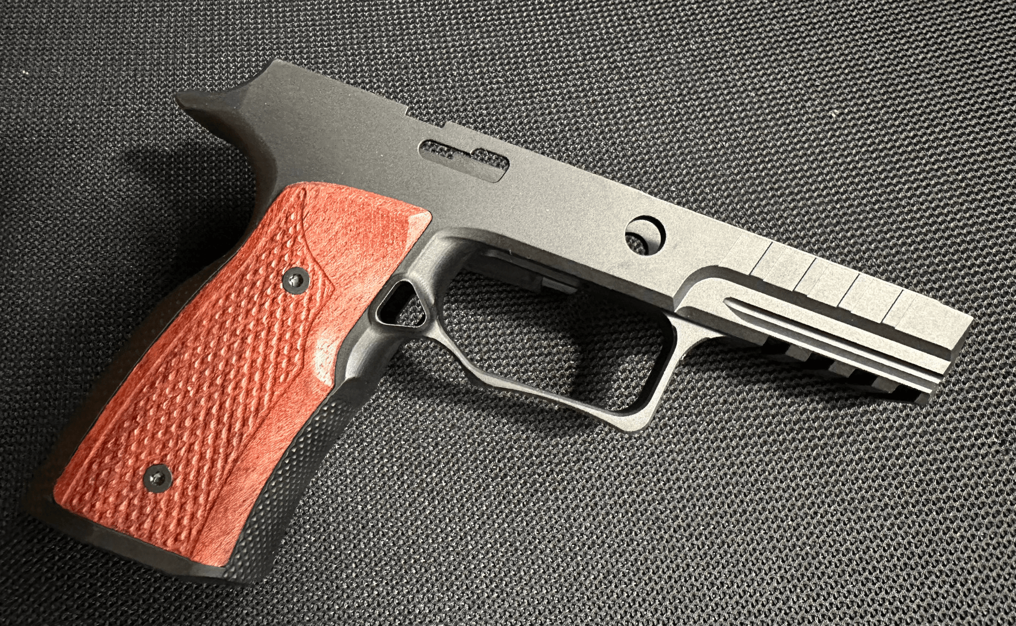 Sharps Bros Sharps 320 improved grip module in black anodize finish with Brazilian Cherry grips and Picatinny rail.
