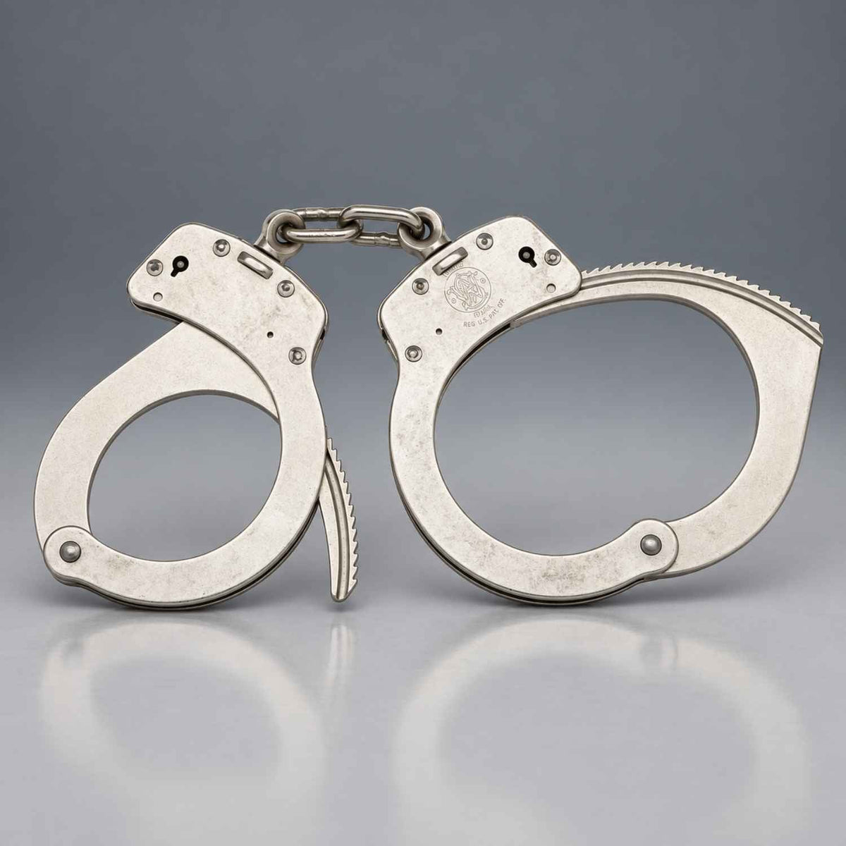 Front view of Smith & Wesson Model 1 nickel chain handcuffs 350132 showing both carbon steel cuffs, double lock pin holes, and S&W logo