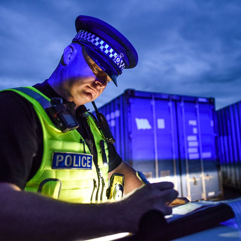 Police officer using a Streamlight MicroStream USB during a nighttime inspection