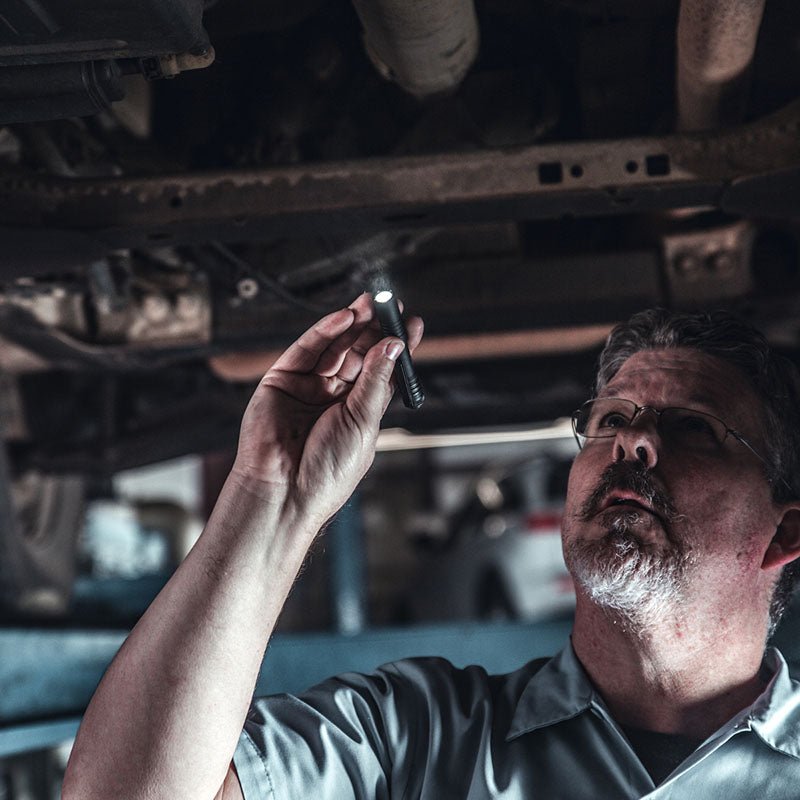 Automotive technician using a Streamlight MicroStream USB under a vehicle