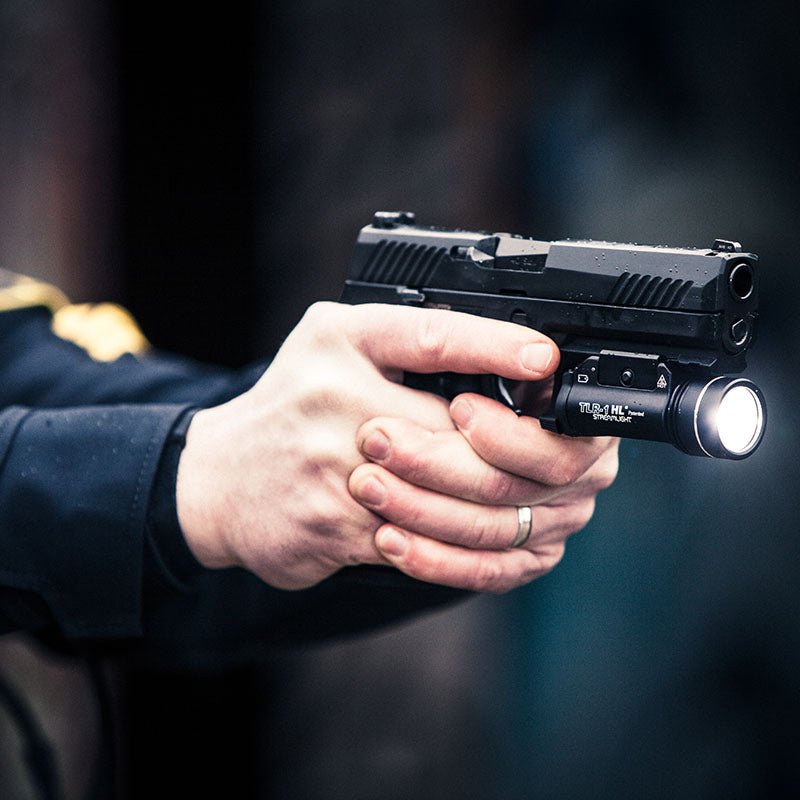 Police officer using a Streamlight TLR-1 HL gun light on a duty handgun