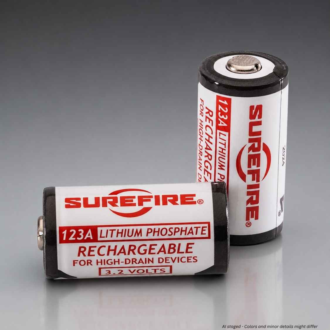 Two Surefire 123A rechargeable lithium phosphate batteries, one lying down and one standing up, on a reflective gray surface.