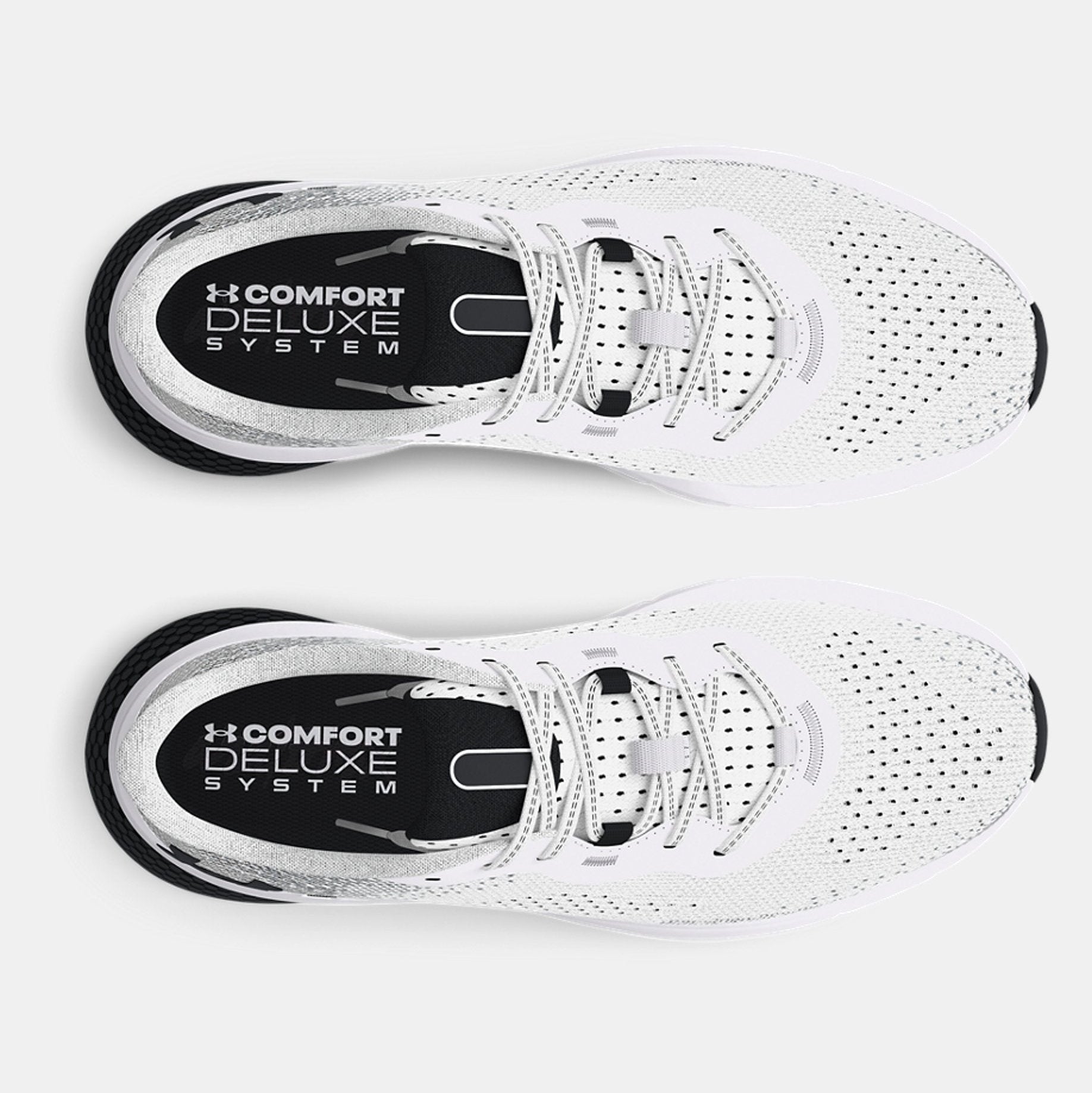 White athletic shoes with 'Comfort Deluxe System' label on a light gray background