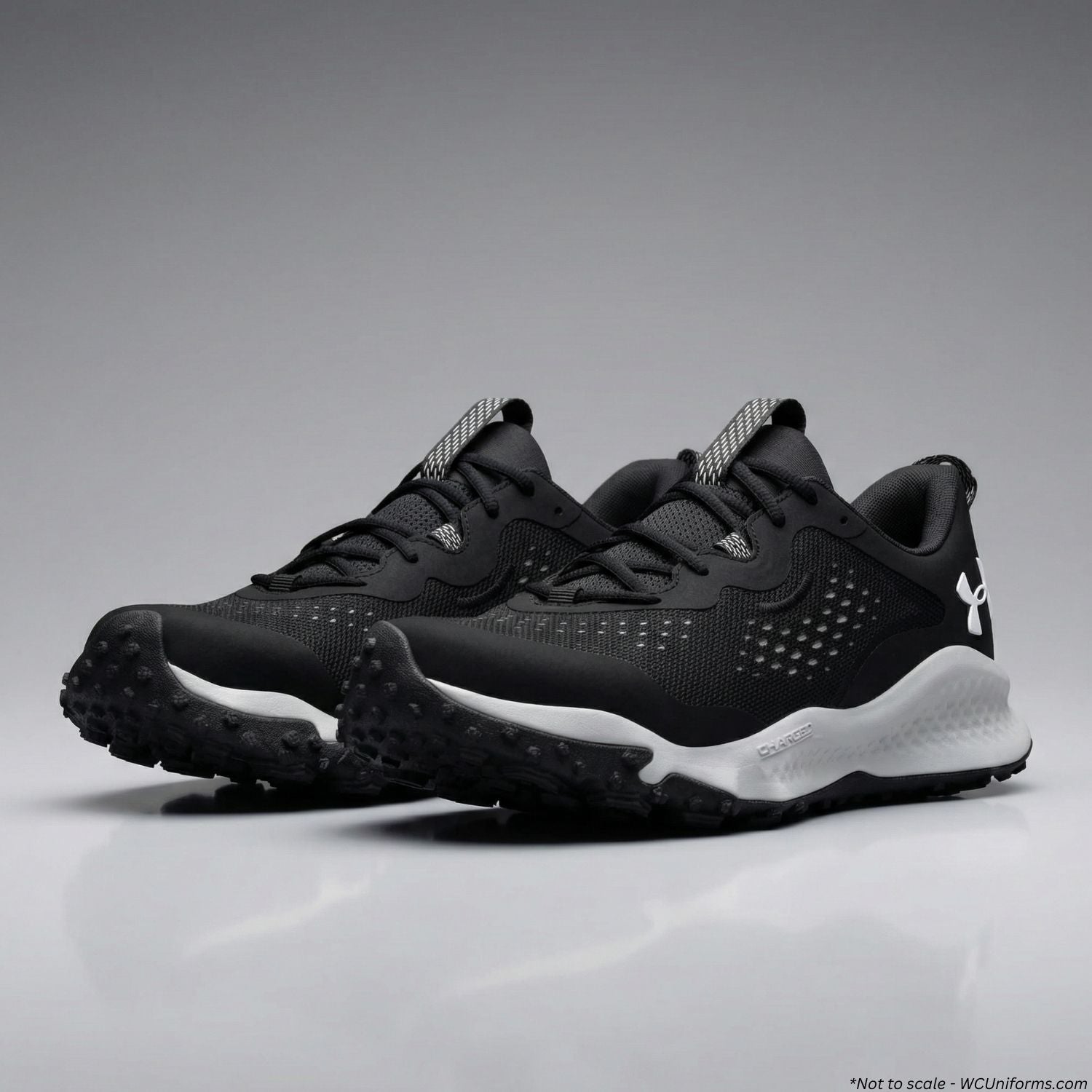 Black athletic shoes with white soles on a gray background
