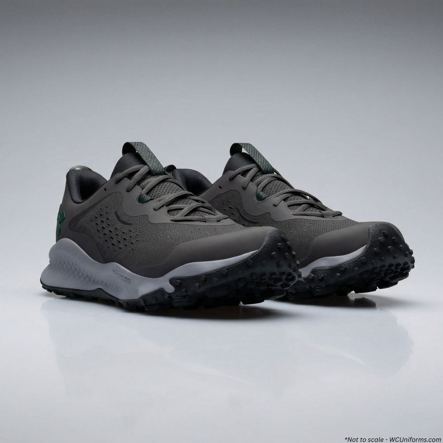 Pair of dark gray athletic shoes with white soles on a light gray background