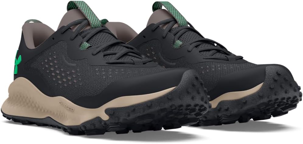 Black and beige athletic shoes with green accents on a white background