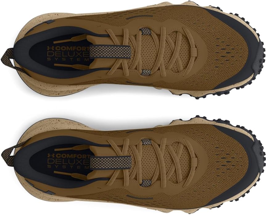 Brown hiking shoes with black soles on a white background