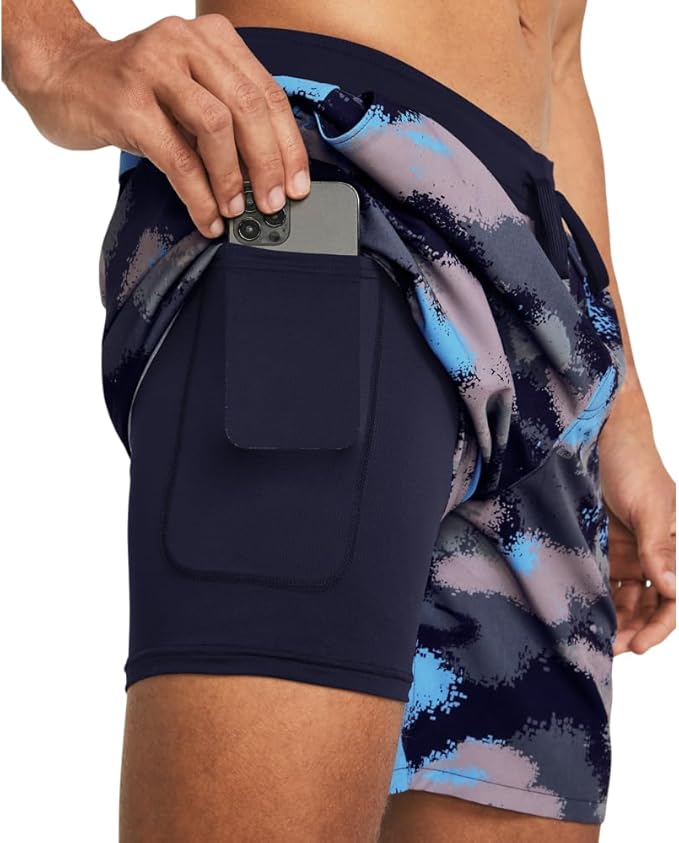 Person wearing navy shorts with a pocket and colorful patterned shorts underneath.