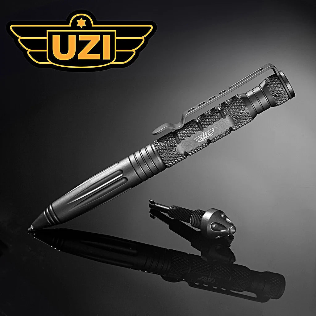 Gun Metal Grey UZI Defender Tactical Pen #6 with glassbreaker and concealed cuff key on reflective surface