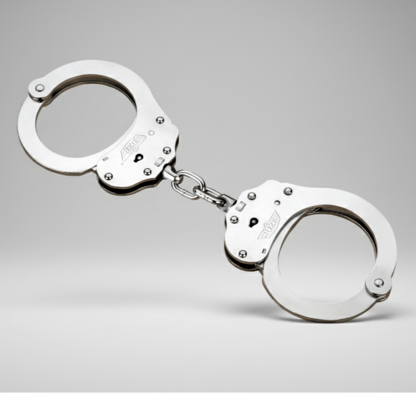 Metallic handcuffs on a gray background