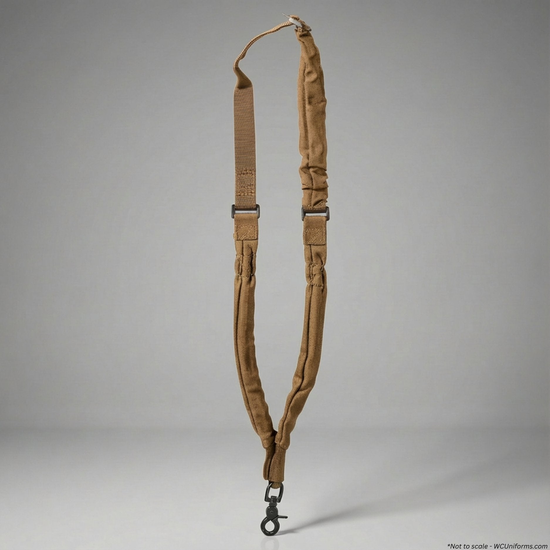 Tan rifle sling with metal hardware on a gray background