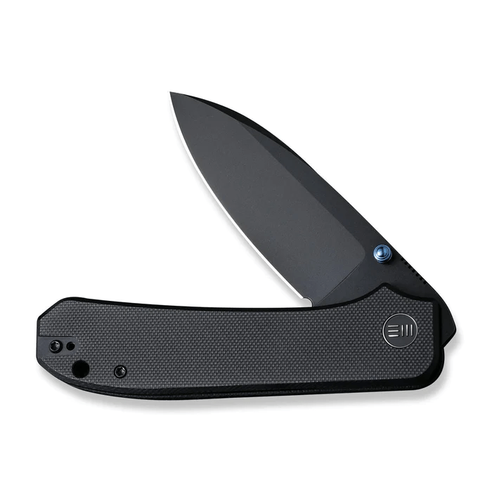We Knife Big Banter Thumb Stud Knife with sleek black handle and sharp blade, designed for quality and innovation.