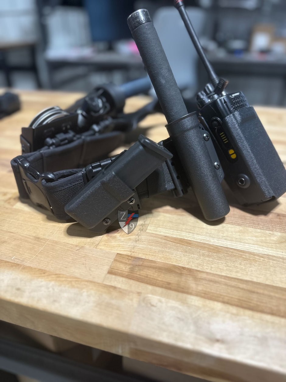 Black tactical equipment on a wooden surface