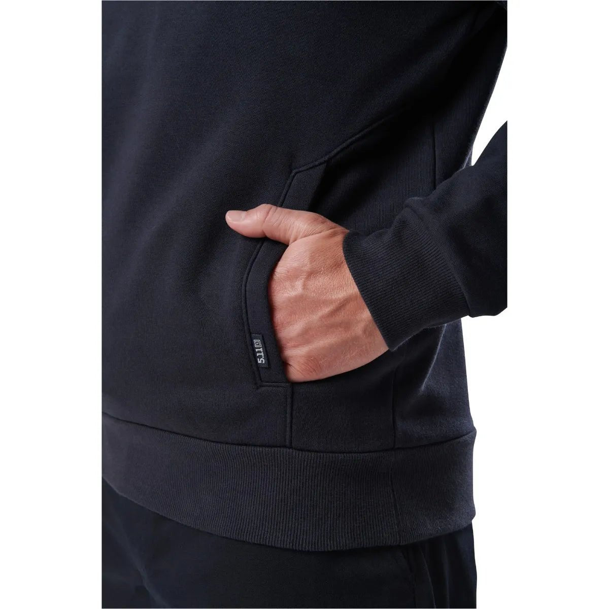 Close-up of a person wearing a 5.11 Tactical Job Shirt 1/4 Zip 2.0, showcasing the hand pocket detail and durable fabric.