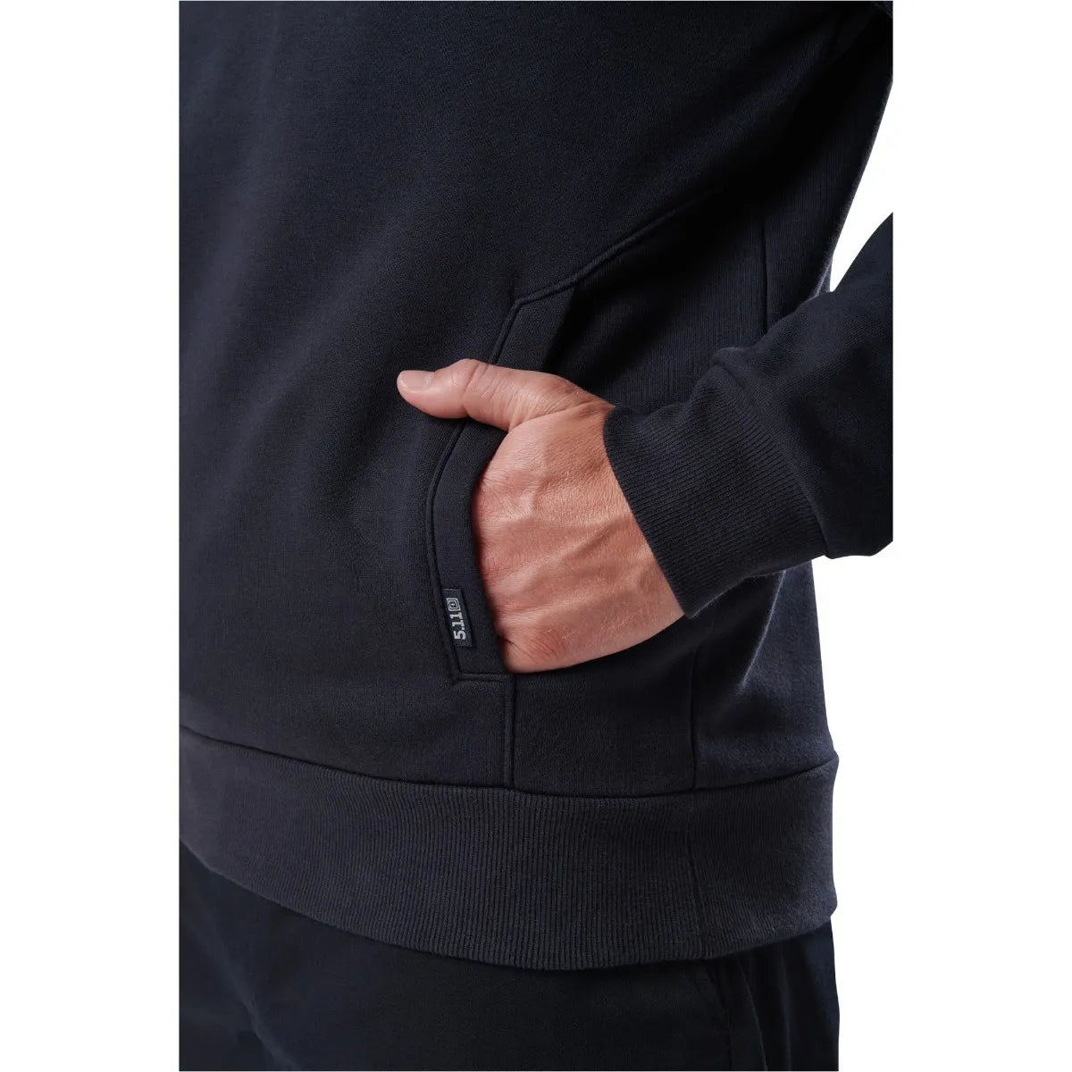 Close-up of a person wearing a 5.11 Tactical Job Shirt 1/4 Zip 2.0, showcasing the hand pocket detail and durable fabric.