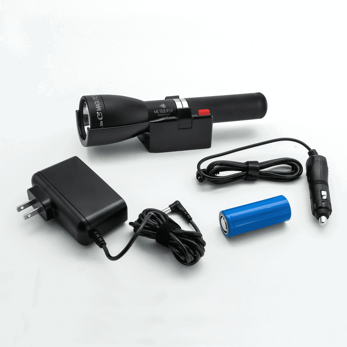 Matte black Maglite ML150LRSX flashlight docked in its cradle beside the wall converter, car charger cord, and LiFePO4 battery