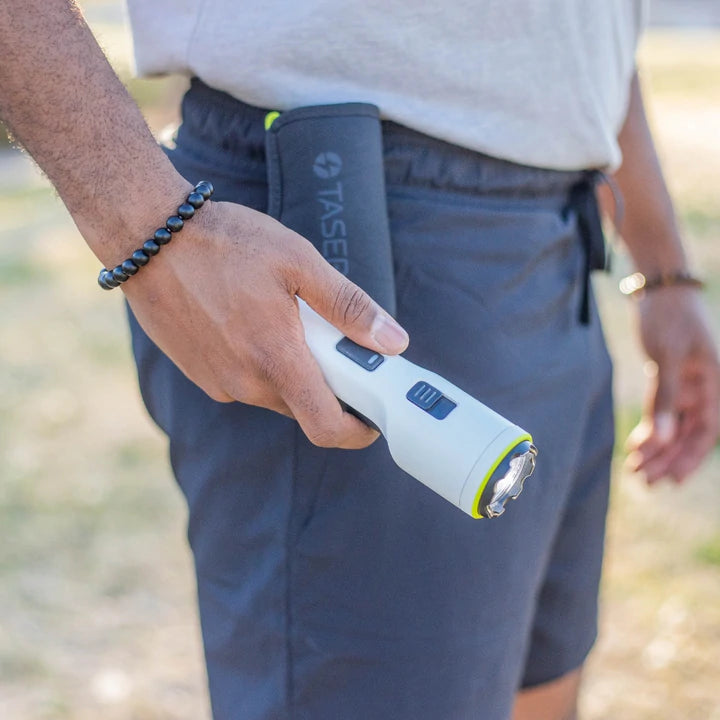 TASER StrikeLight 2 white stun gun showing stun arc discharge between electrodes